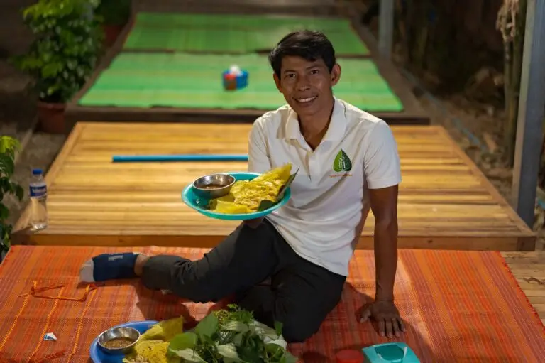 Street Food Tour Leader on a Siem Reap Street Food tour showing local food